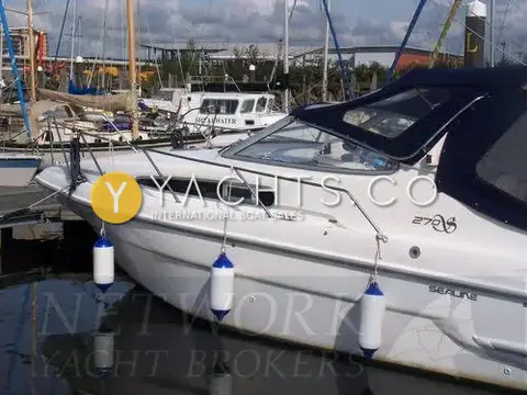 Sealine International Sealine 270 Reduced: port bow and side of white hull with 270 decal, canopy and fenders in marina