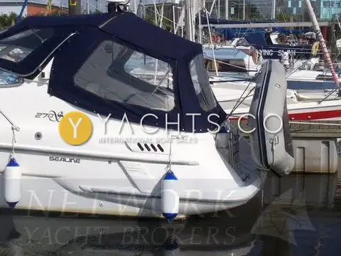 Sealine International Sealine 270 Reduced: aft quarter showing navy cockpit canopy and dinghy stowed on stern davits