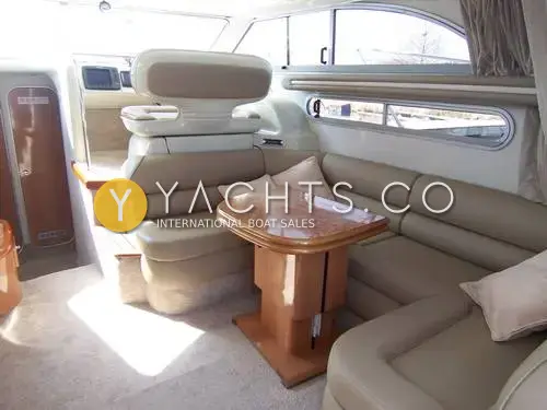 Sealine International Sealine 360 Statesman: saloon with cream leather U-shaped seating, burr wood table and lower helm seat beyond