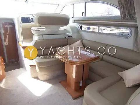 Sealine International Sealine 360 Statesman: saloon seating in cream leather around a pedestal table, sunlight across the carpet