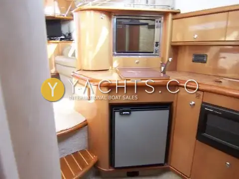Sealine International Sealine 360 Statesman: galley with cherry wood units, built-in fridge, oven and steps down from saloon