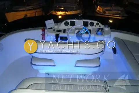 Sealine International Sealine 410 Aft Cabin: flybridge helm and seating at night with blue LED lighting under the seats