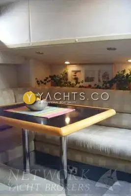 Sealine International Sealine 410 Aft Cabin: lower dinette with checked upholstery and black-topped table with wooden trim