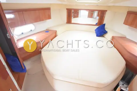Sealine International Sealine F34: forward cabin island double berth with cream upholstery and gloss wood lockers