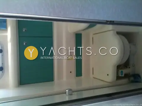 Sealine International Sealine S28 Reduced: heads compartment with marine toilet and green-fronted cabinets, photographed on its side