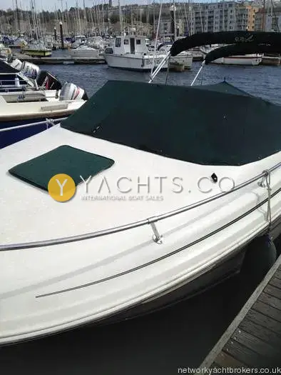 Sea Ray 215 Express Cruiser: foredeck and bow rail with green canvas cover fitted over the cockpit