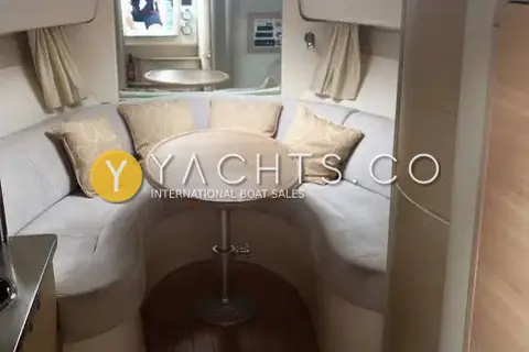 Sessa Marine Sessa C30: saloon with U-shaped grey sofa, patterned cushions and round pedestal table