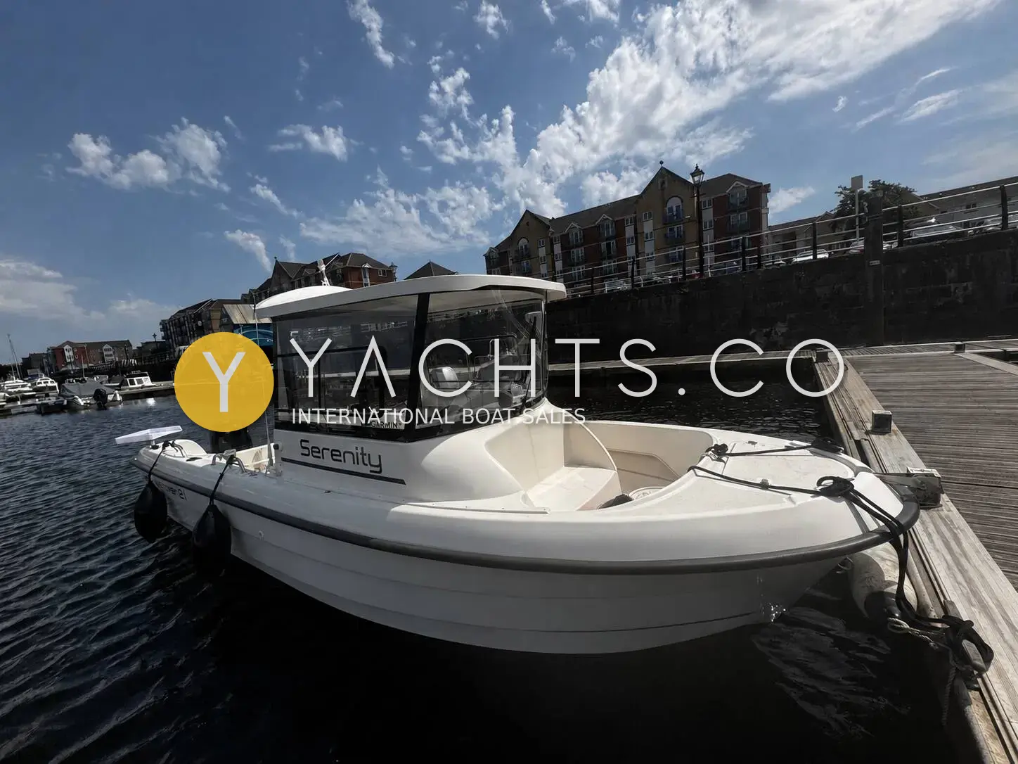 Smartliner 21 Fisher: white fishing boat with offset wheelhouse moored at a marina pontoon beside waterside apartments