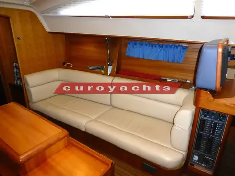 Southerly 38: saloon settee with blue curtains, chart table panel visible to the right