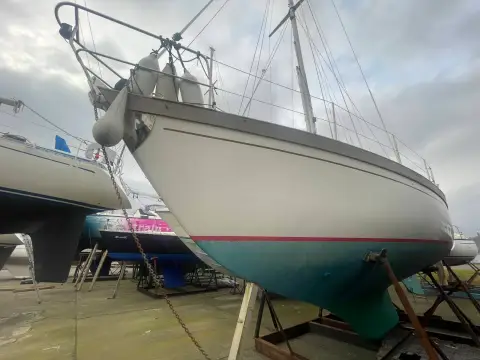 Sovereign 32 Deck Saloon: hull ashore on cradle seen from the bow quarter, mast stepped