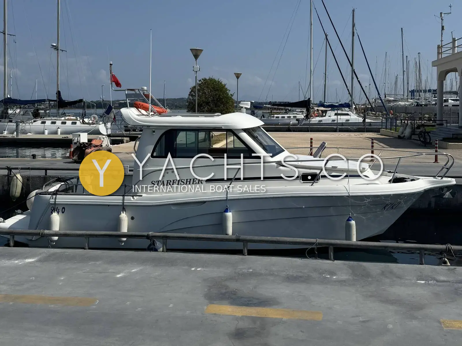 Starfisher 840: white hull and wheelhouse with Starfisher lettering, moored stern-to on a marina quay