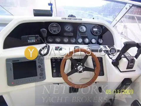 Sunseeker Martinique 36: helm console with wooden wheel, chart plotter, VHF radio, gauges and twin throttles