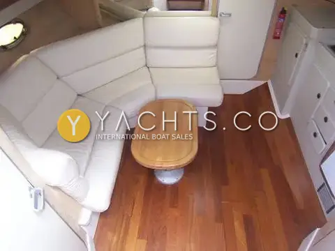 Sunseeker Martinique 36: saloon with cream leather L-shaped seating, oval wooden table and timber floor