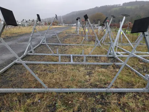 Tennamast 6 Post Yacht Cradle: cradle base frame with adjustable posts and square pads, other cradles in the yard behind