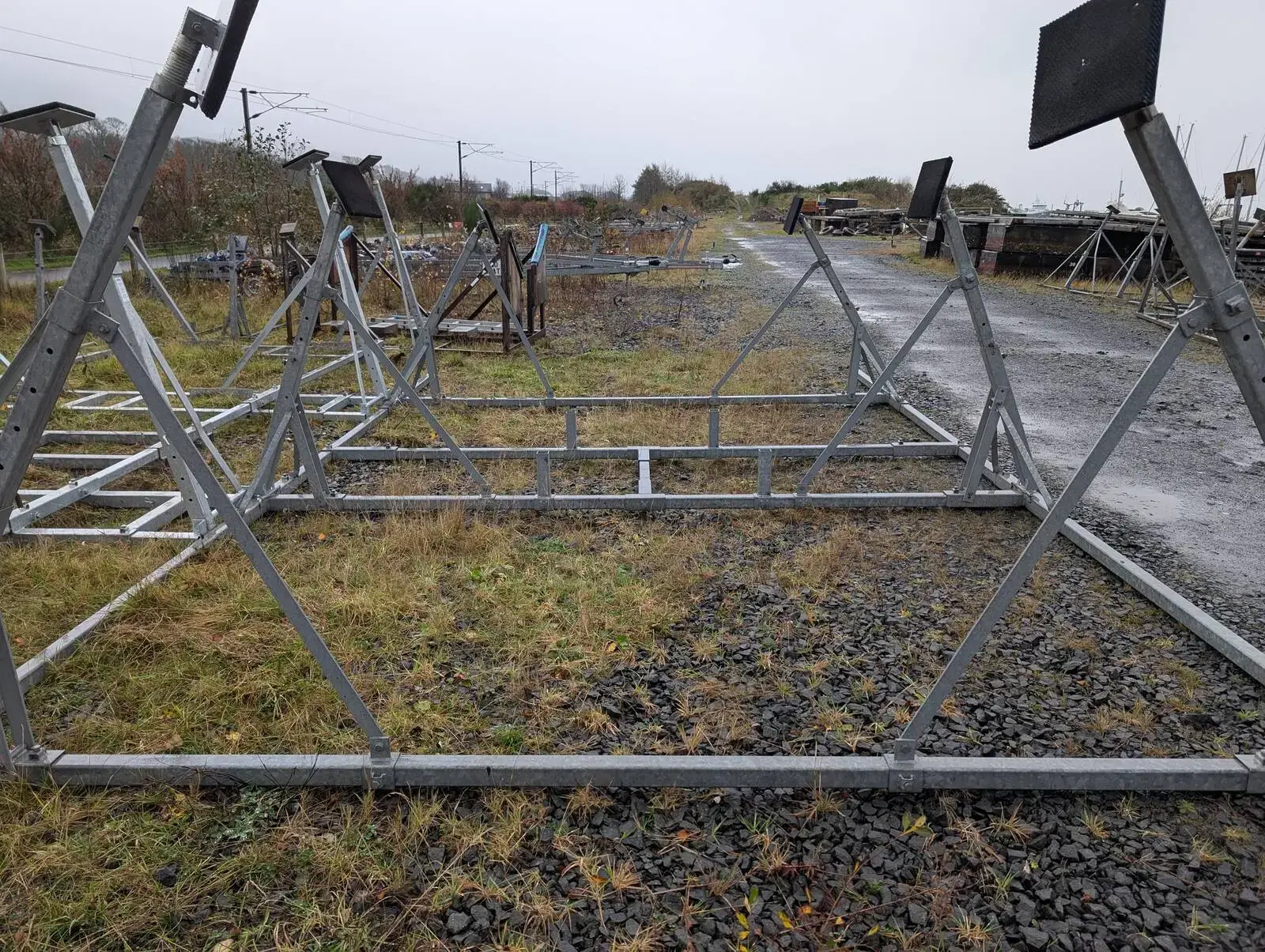 Tennamast 6 Post Yacht Cradle: galvanised six-post cradle frame laid out on grass beside a yard track, posts and pads visible