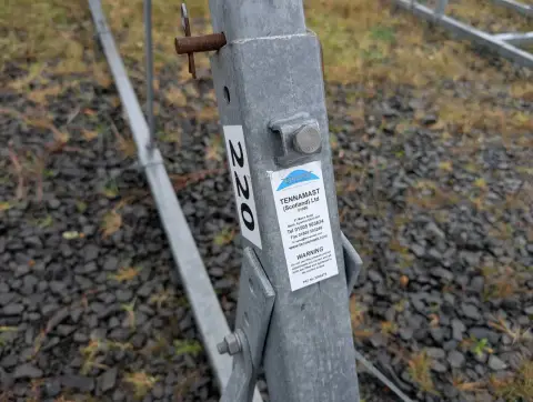 Tennamast 6 Post Yacht Cradle: close-up of a cradle post showing a manufacturer's label, numbered tag and locking pin