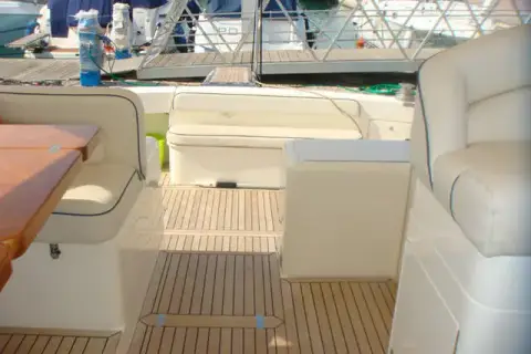 Uniesse 42: cockpit seating with cream upholstery, teak table edge and teak-laid sole