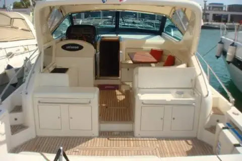 Uniesse 42: cockpit with teak deck, white storage units and open companionway to the helm area