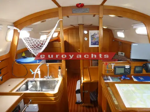 Vancouver 34: interior looking forward past galley sinks and chart table with instruments