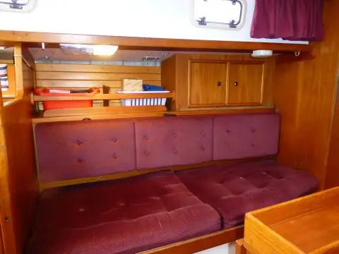 Victoria 30: port saloon settee with shelving and cupboard above in warm wood finish