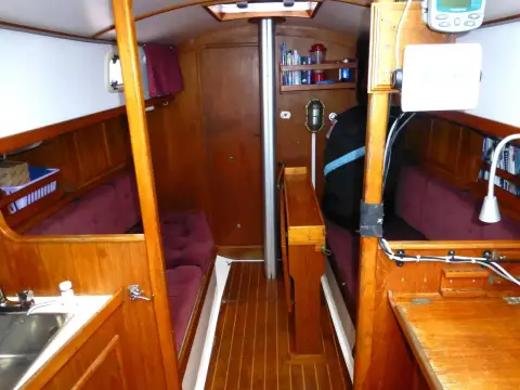 Victoria 30: saloon viewed from the galley with sink, chart table and teak-and-holly sole