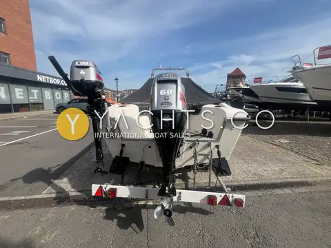 Warrior 165: stern view showing main outboard and smaller auxiliary outboard on the trailer