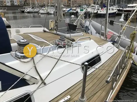 Westerly Oceanquest 35 CC: aft deck with teak decking, winches on the coaming and a tender on davits astern