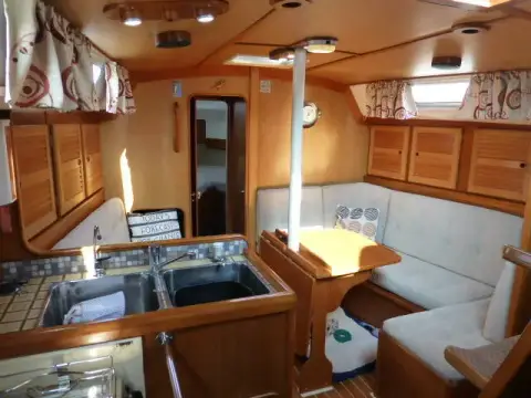 Westerly Seahawk 34: galley sinks in the foreground with U-shaped settee and drop-leaf table beyond