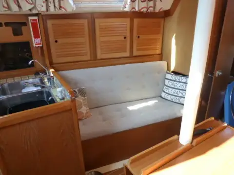 Westerly Seahawk 34: port bench settee below ash lockers with louvred doors