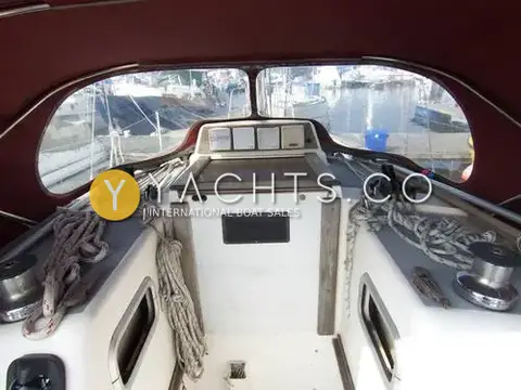 Westerly Tempest: cockpit view forward under burgundy sprayhood towards companionway and instrument displays