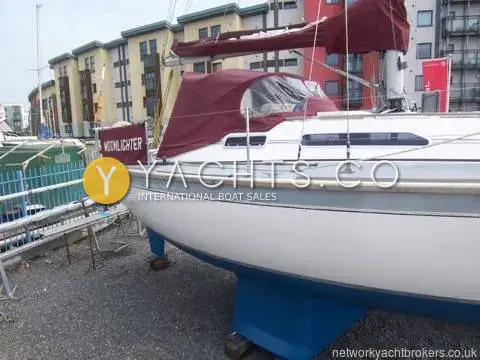 Westerly Tempest: hull topsides and bilge keel ashore beside apartment buildings