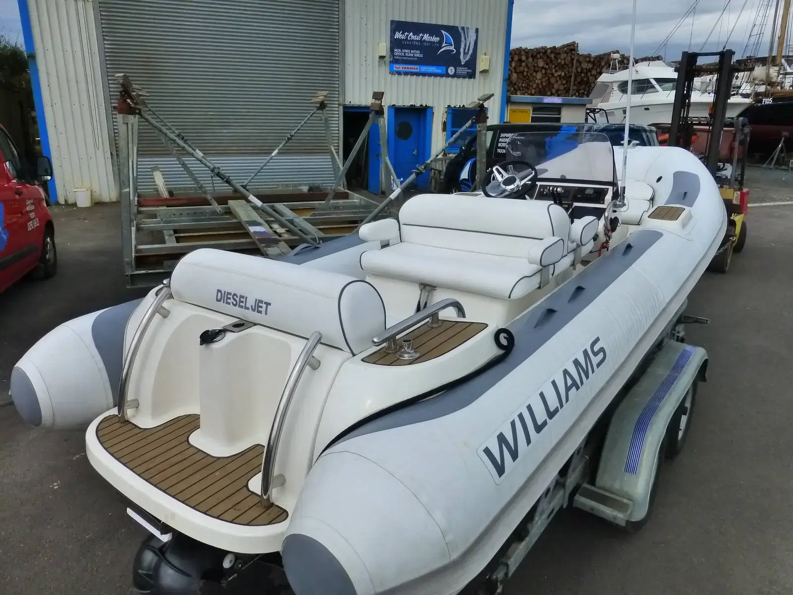 Williams DieselJet 505: port quarter view ashore on a trailer showing white seating, teak-effect deck and grey tubes