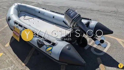 Zodiac Mk 2 Classic Sib Airdeck: bow quarter view showing airdeck floor, grey tubes and tilted outboard on tarmac